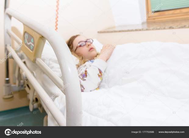 Preschooler child is lying sick on a bed in hospital room